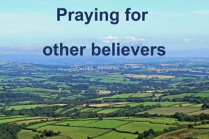 A view of Cornish countryside looking over Liskeard with the caption "Praying for Other Believers"